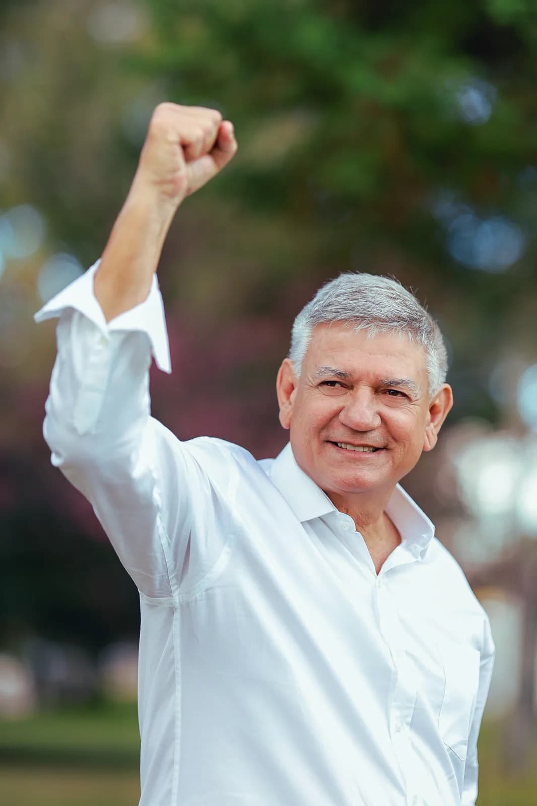 Helio Wirbiski sorrindo e erguendo o punho